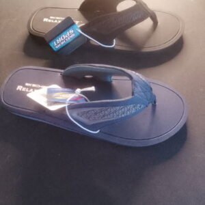 A pair of blue and black flip-flops on a dark surface.