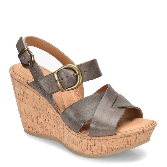 Brown wedge sandals with cork platform and buckle strap.