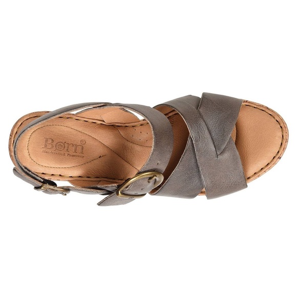 Top view of a brown leather sandal with a buckle strap.