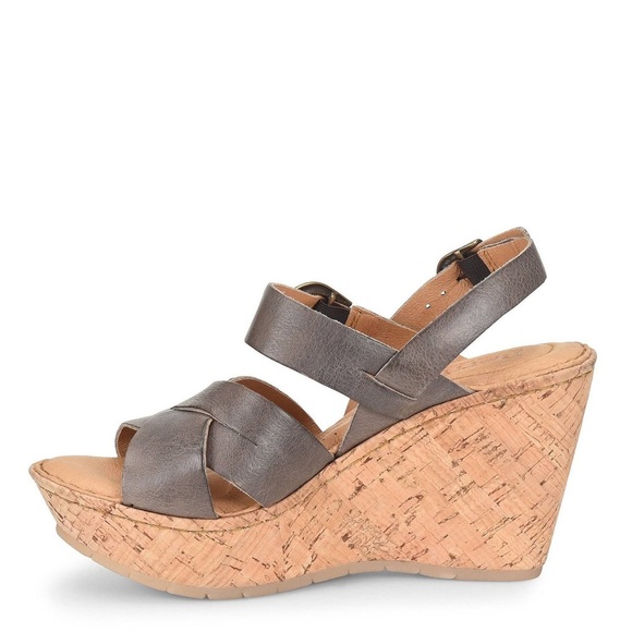 Brown wedge sandals with cork heels and ankle straps.