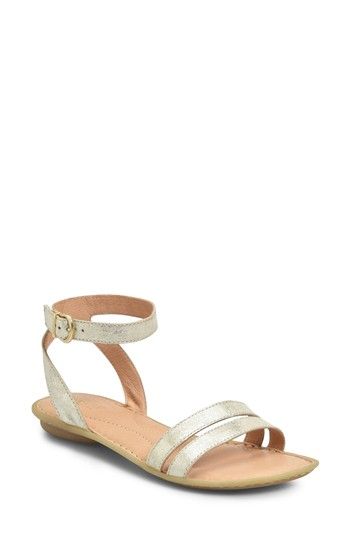 Elegant gold ankle-strap sandal with block heel.