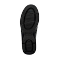 Black sole of a shoe with textured grip patterns.