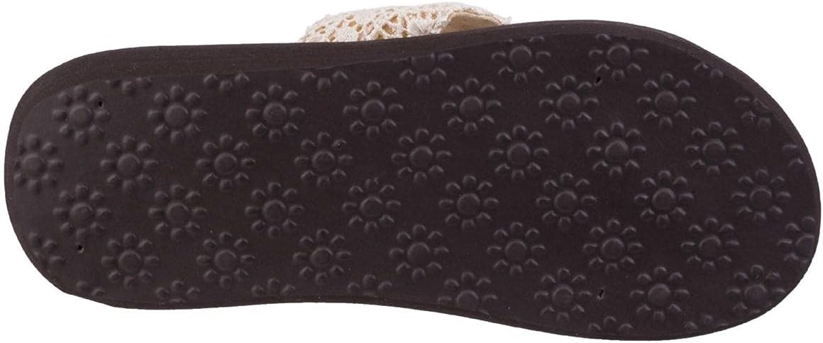 Close-up of a dark shoe sole with paw print patterns.